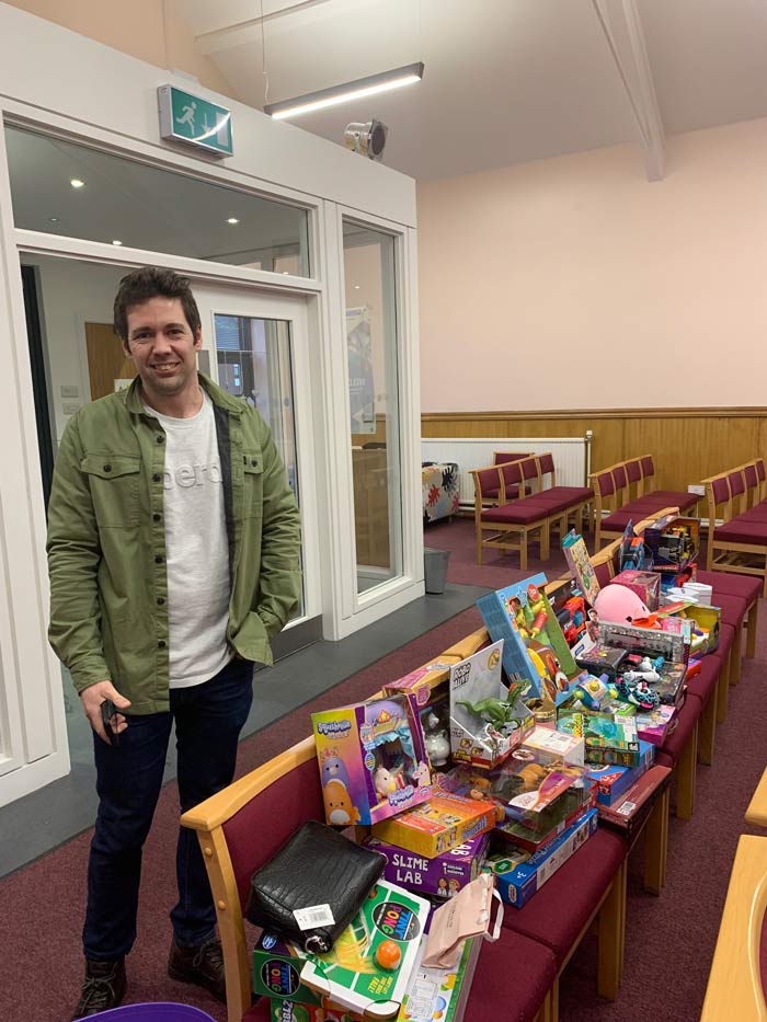 Operations Manager, Alex Ashton with a collection of toys for the Salvation Army appeal in the Toryglen office