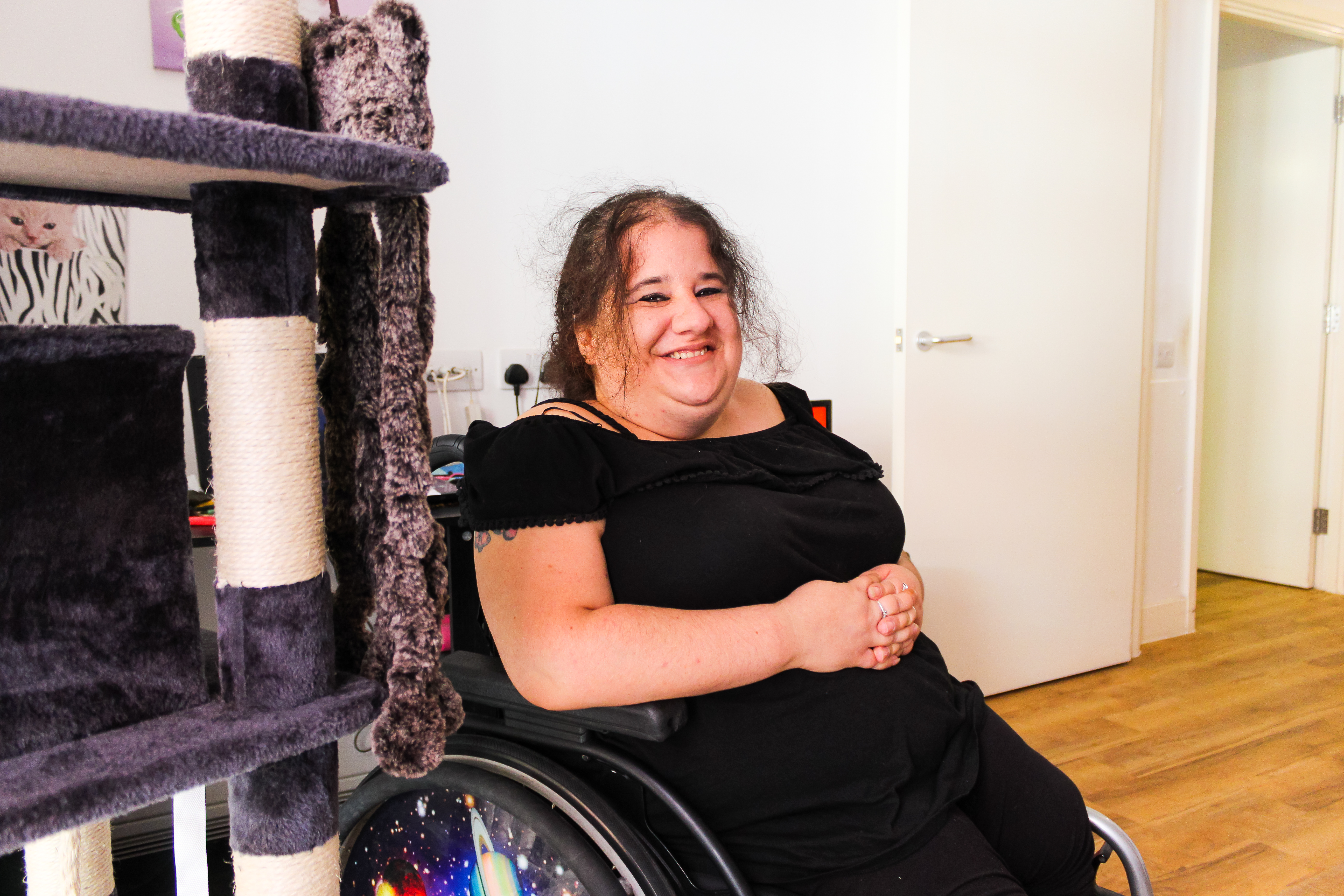 A woman in a wheelchair smiling
