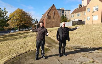 Estate Staff Supervisor Chris Wilson and Friar Gerald Byrne standing in the church grounds