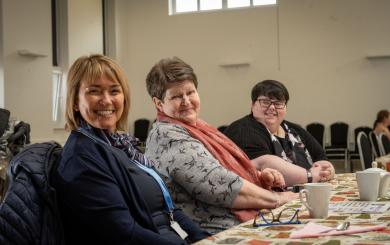 Lorraine Quinn, Isabel Kerr and Natasha Cox sat at a table smiling