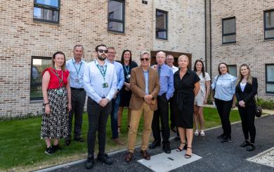 Sanctuary staff and key stakeholders including Glasgow City Council representatives stood outside Anchor Court in Yoker