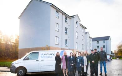 Representatives from Sanctuary pose in front of a Sanctuary Scotland maintenance van at the East Kilbride housing estate 