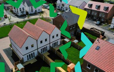 Aerial photograph of a housing development with terraced, semi-detached and detached homes with gardens separated by wooden fences