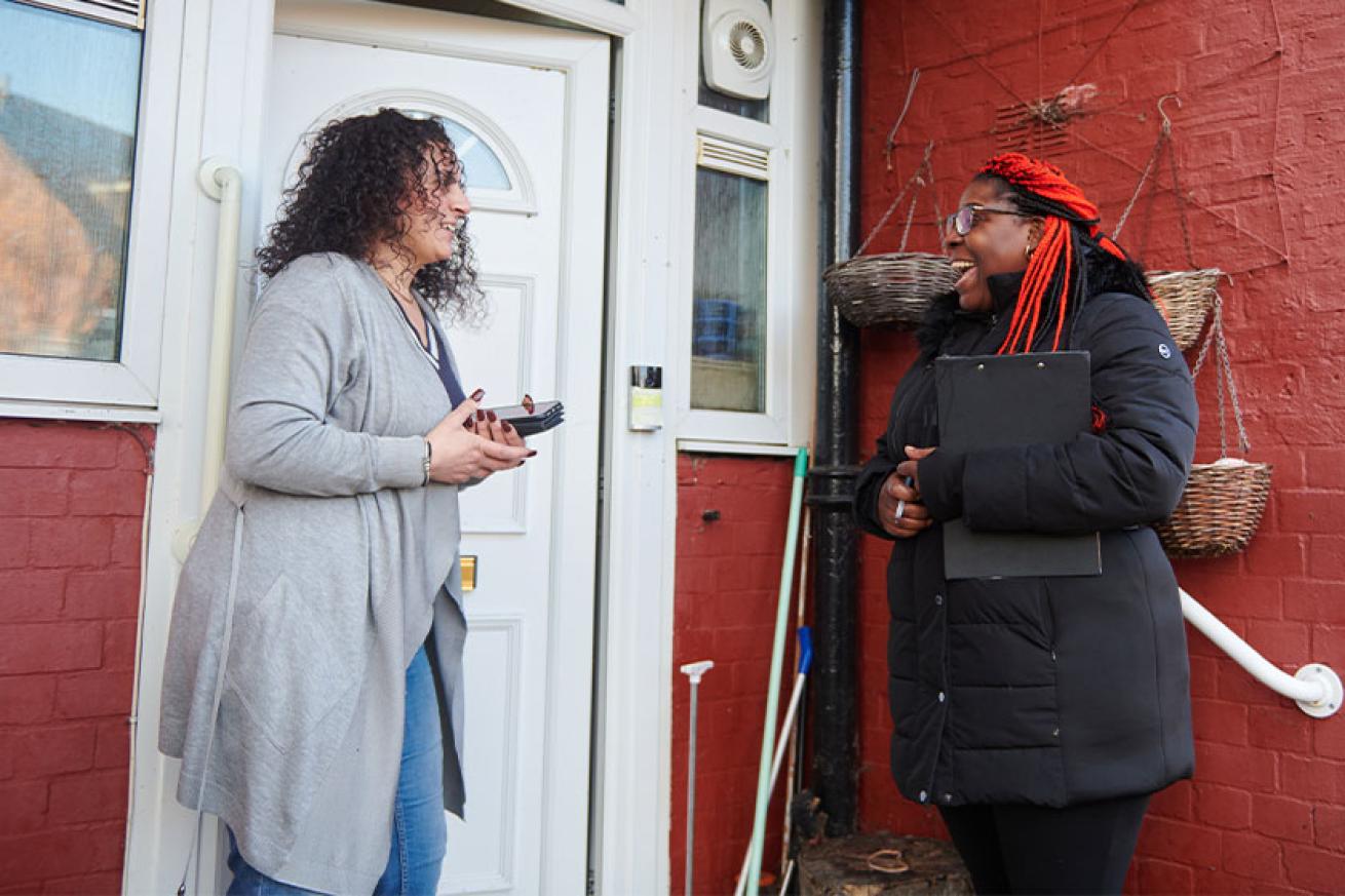 Sanctuary staff speaking to a resident outside their house