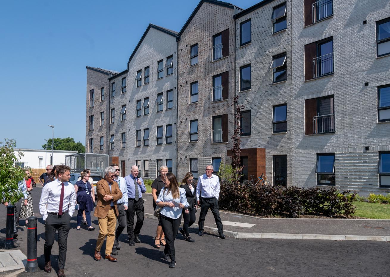 A picture of Sanctuary staff and Glasgow City Council representatives touring the development on an official visit
