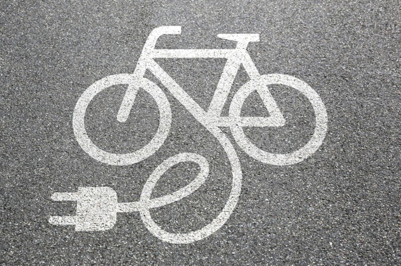 E-bike symbol painted in white paint on a grey tarmac