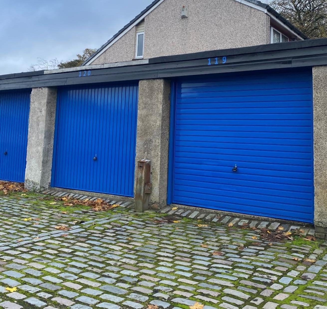 3 garages with blue doors
