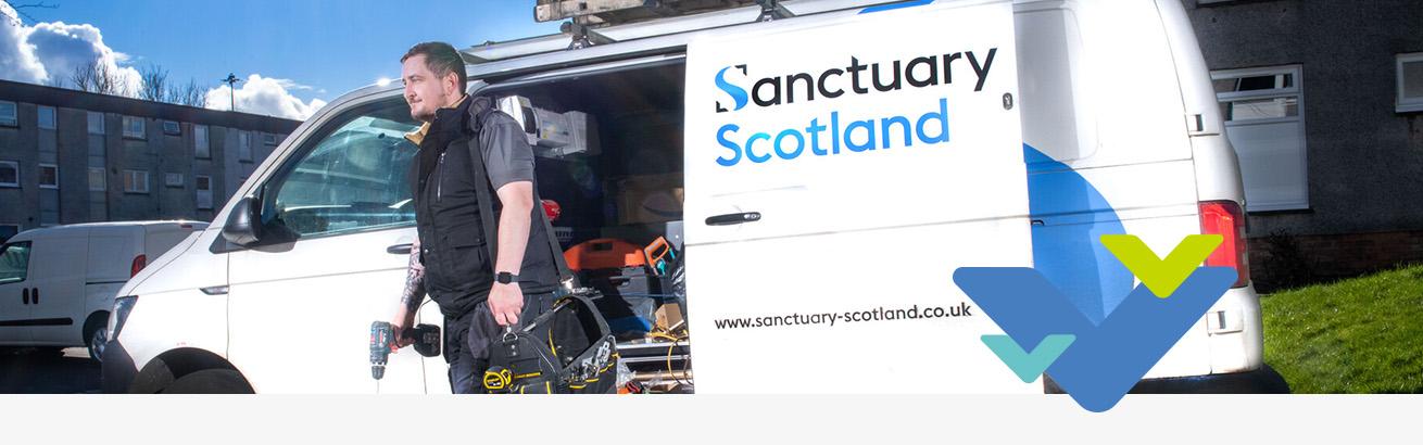 Chris a trade operative carrying tools away from his Sanctuary Scotland branded white van.