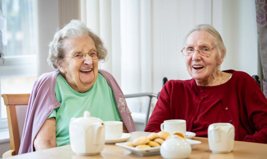 Two Sanctuary Care residents enjoying a cup of tea