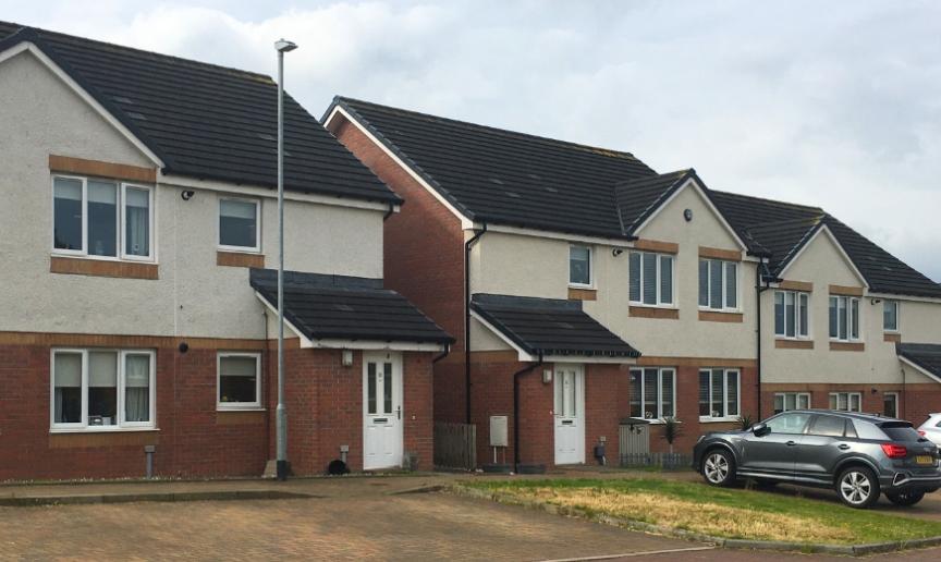 A row of semi-detached houses with driveways at the front of the properties 