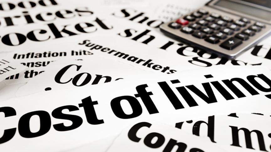 Stock image of a calculator with 'Cost of Living' written underneath