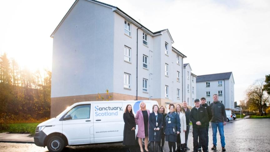 Representatives from Sanctuary pose in front of a Sanctuary Scotland maintenance van at the East Kilbride housing estate 