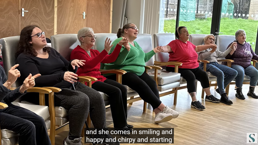 Sanctuary residents sat in a hall singing in the choir