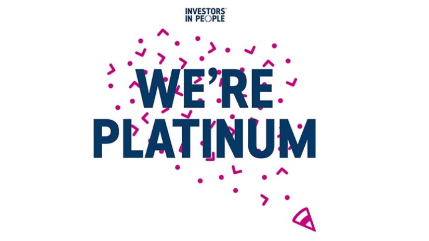 Graphic with the Investors in People logo at the top and bold text reading 'We’re Platinum' in dark blue, surrounded by pink confetti shapes on a white background.