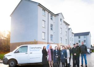 Representatives from Sanctuary pose in front of a Sanctuary Scotland maintenance van at the East Kilbride housing estate 