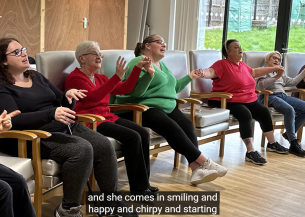 Sanctuary residents sat in a hall singing in the choir